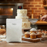 Bakery scene with muffins, a cake, and a bag of icing sugar in a kitchen setting.