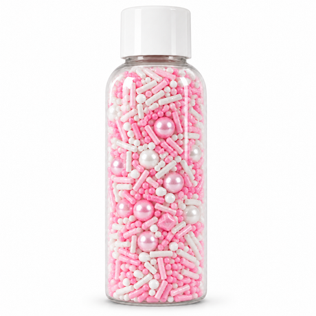 A clear plastic bottle filled with pink and white sprinkles, including sugar pearls and coated sticks, with a white cap, shown on a white background.