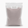 A clear resealable stand-up pouch filled with a pale pink cake mix, labeled 'Honey Bee Red Velvet Cake Mix' on a white background.