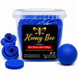 A clear plastic tub filled with bright blue silicone items, with several loose blue silicone pieces arranged around it on a white background. The front of the tub has a black label with a yellow bee logo and the text 'Honey Bee Lifestyle'.