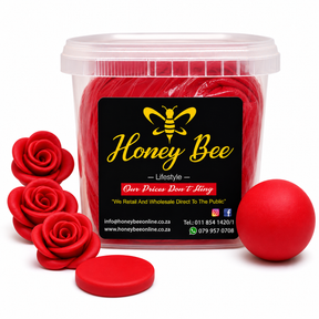 A clear plastic tub filled with bright red wax melts, featuring a black label with a yellow bee logo and the brand name 'Honey Bee'. The tub is styled with three red wax rose petals on the left, a single red wax ball on the right, and a small round red lid piece in front, all on a clean white background.