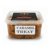 A clear plastic tub of Honey Bee Caramel Treats with a white label reading 'CARAMEL TREAT' and a black lid label showing the Honey Bee brand.