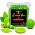 A clear plastic tub filled with bright green coiled material, labeled Honey Bee Lifestyle, shown with green decorative accessories including a smiling caterpillar figure, leaf-shaped pieces, and a round green ball on a white background.