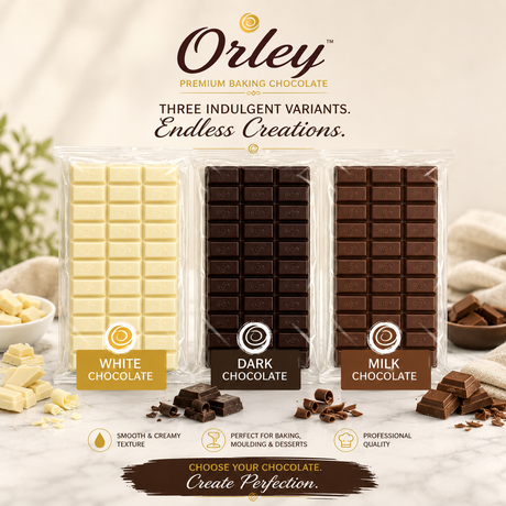 Three bars of Orley premium baking chocolate in white, dark, and milk chocolate flavors, displayed side-by-side with decorative chocolate pieces and cream on a light marble surface.