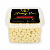 A clear plastic tub filled with pale yellow honeycomb wax melts, featuring a black label with gold and red text that reads 'Honey Bee Lifestyle'.